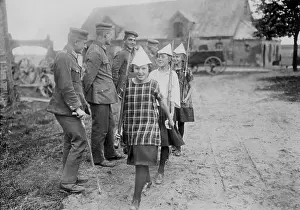 Quartered: Girls parade with paper helmets, 1925