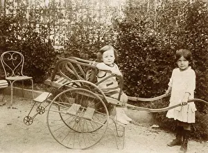 Footrest: Two girls playing with a push cart