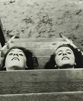 Ermanno: Two girls putting their heads through