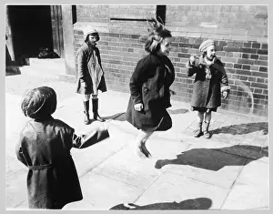 Overcoats: Girls skipping, 1930s