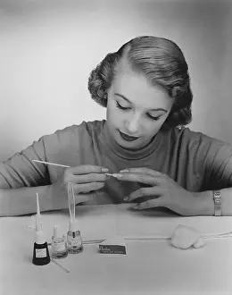 Fingernails: Giving herself a manicure