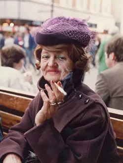 Smokes: Glamorous elderly lady smoking