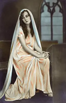 Contrition: Glamorous French beauty in pious pose