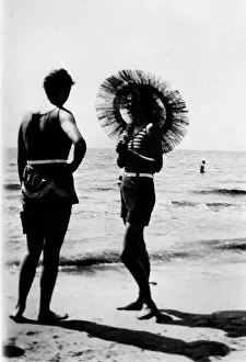 Sunshade: Glamorous lady with a sunshade parasol on a beach