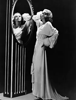 Snob: Glamorous woman looking in mirror