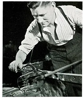 Blower: Glass blower fixing a handle on a jug