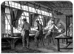 Rotating: Glass cutters at their wheels. Vessel to be cut
