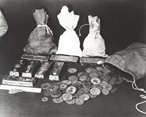 Bullion: Gold coins and bars laid out on table
