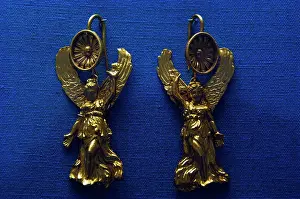 Earring: Golden earrings with shaped like a Nike