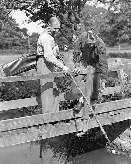 Bastin: Two golf players on a bridge