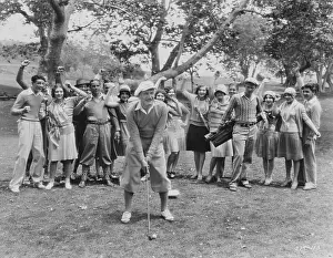 Teeing: Golfer teeing off in front of spectators