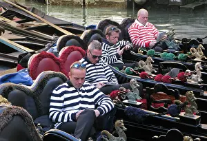 Gondolas: Four gondoliers in their gondolas behind St Mark's, Venice