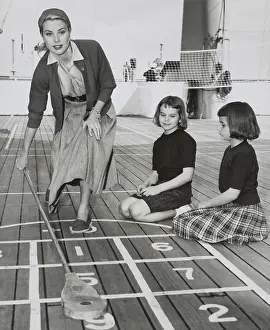 Nieces: Grace Kelly by playing shuffleboard on the deck