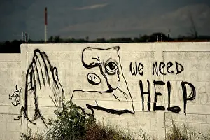 Pleas: Graffiti asking for help is painted on a ?