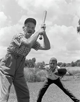 Mitt: Grandfather at bat with boy as catcher playing