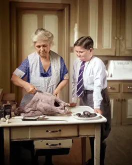 Grandparent: Grandmother in Apron Preparing a Turkey in the