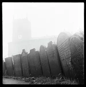 Subsidence: Gravestones lining a pathway in the churchyard