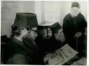 Executing: Greek monks reading the newspapers