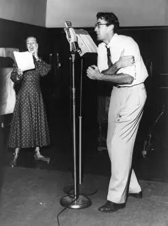 Hitchhiking: Gregory Peck at microphone with Kay Brinker in