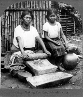 Guadalupe: Grinding corn for tortillas with a metate ?