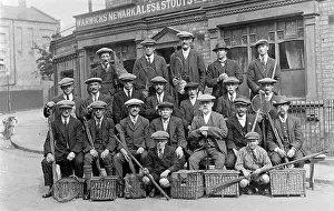 Rods: Group of fishermen with baskets and rods outside a pub