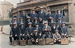 Rods: Group of fishermen with baskets and rods outside a pub