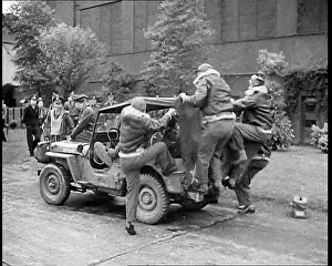 Jeep: A Group of Male Pilots Climbing onto a Jeep