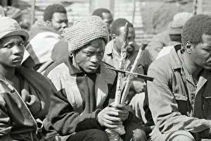 Assegais: A group of men, some armed with traditional weapons