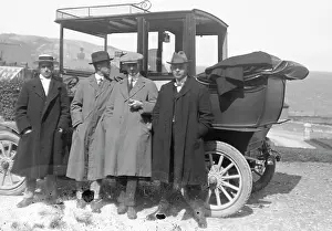 Group of men by a car