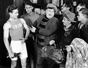 Well Being: Group of men looking at an athlete