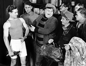 Well Being: Group of men looking at an athlete