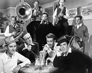 Cooperate: Group of men sitting in a diner with musicians behind them