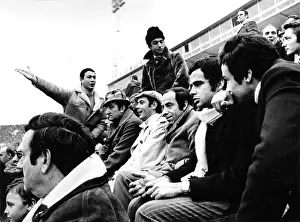 Reacting: Group of men in sports stadium