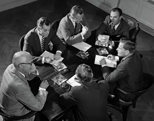 Businesspeople: Group of six men talking around a conference