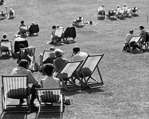 Kenwood: Group of people on deckchairs in a park with shadows