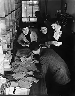 Messes: Group of people going through a pile of mail