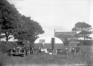Caravan: A group of five people having tea outside a caravan