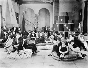 Rarity: Group of people sitting on oversized cushions in a hall