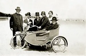 Michael Cole: Group of people with vintage motorcycle combination on beach