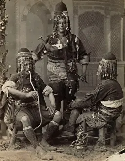 Bazouks: Group portrait of three men, one smoking a nargile; possibly