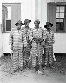 Traditionally: A group of prisoners chained together in a