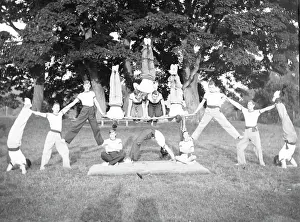 Acrobatics: Group of servicemen doing acrobatics in a field