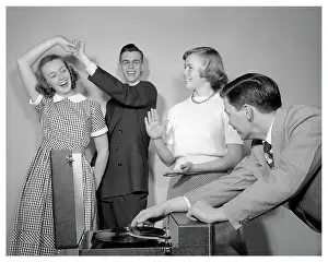 Jitterbug: Group of Smiling Teenagerss Two Couples Playing