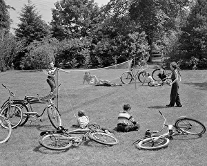 Twill: Group of Teens Lying in Grass with Bicycles Boy