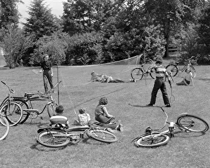 Twill: Group of Teens Playing Badminton Outdoors Lying