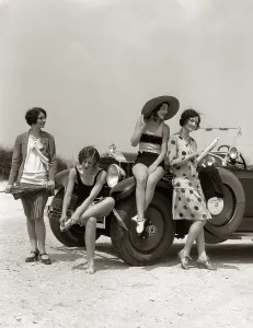Convertibles: Group of four women at shore gathered around