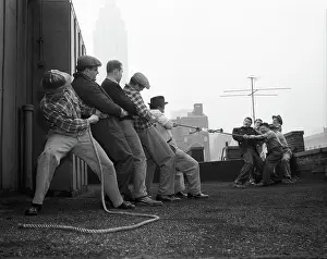 Glued: Two Groups of Five Men Each Pulling on Tug-Of-War Rope