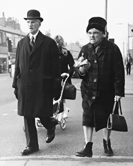 Strolling: Grumpy elderly couple out shopping