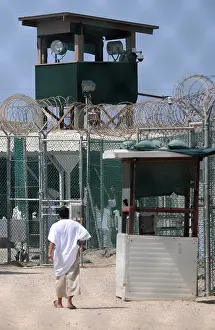 Detainee: Under the guard tower a detainee walks in ?