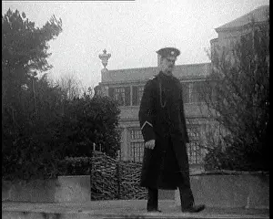 Stately: A Guard Walking Along The Sea Front and Passing